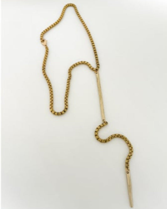 Gold chain necklace with bar detailson a white background