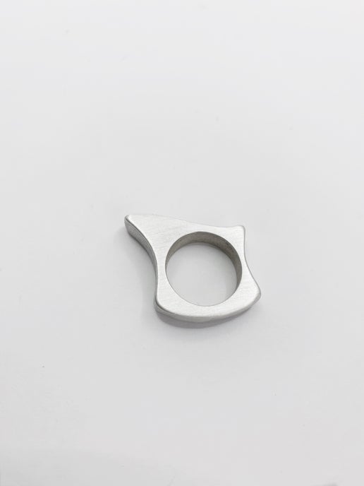 Silver ring with a geometric design on a light grey background