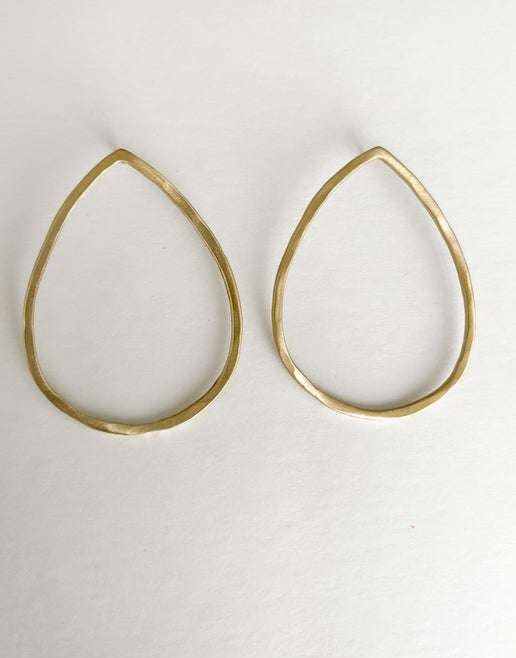 Gold teardrop-shaped earrings on a white background