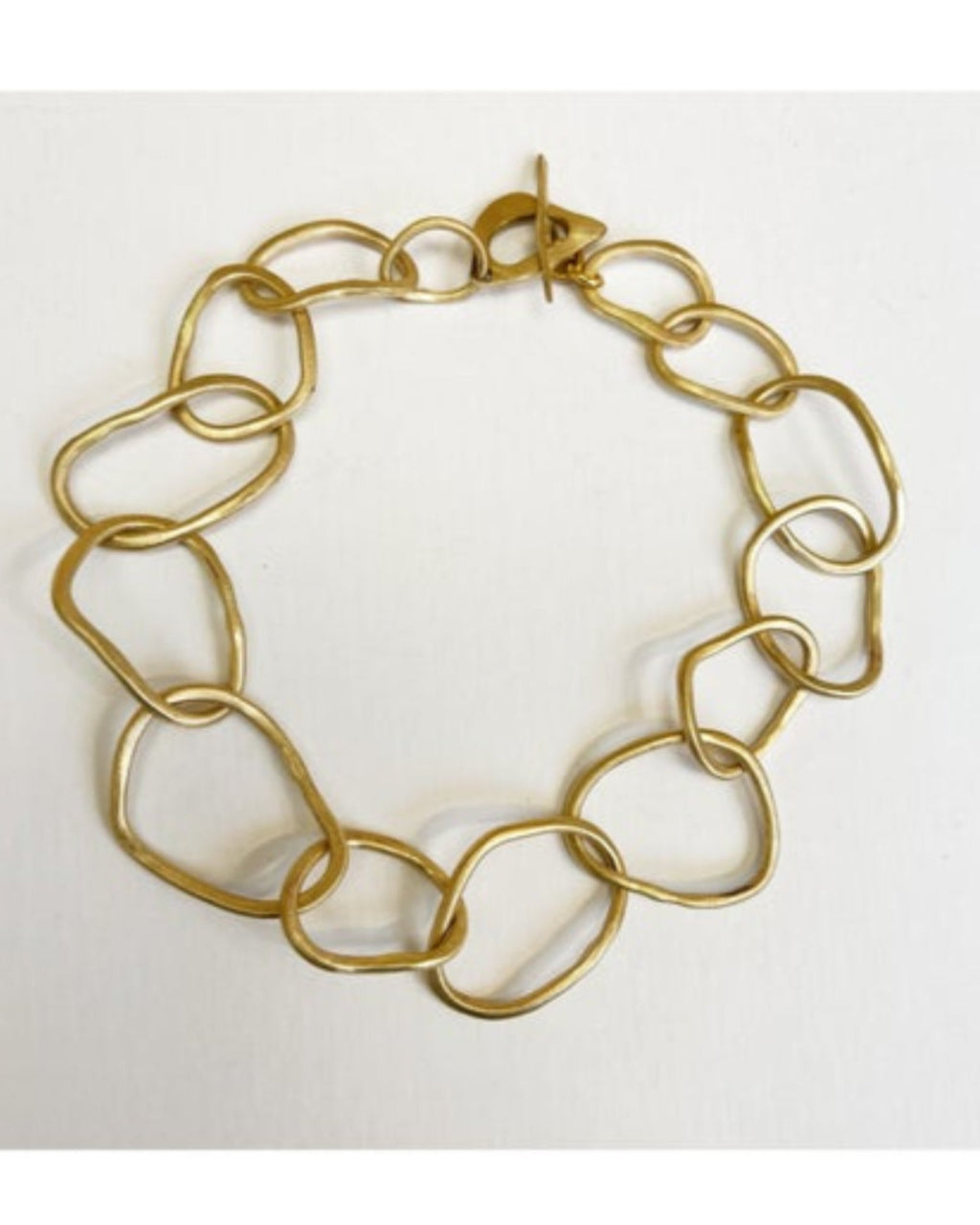 Gold link necklace on a white background