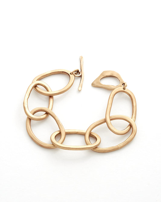 Gold chain-link bracelt on a white background