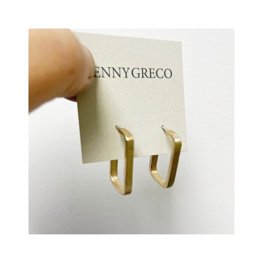 Gold earrings displayed on a Jenny Greco card against a white background