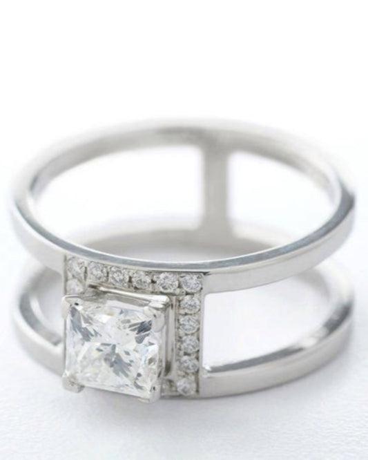 Silver ring with a large square-cut gemstone and smaller diamonds on a white background