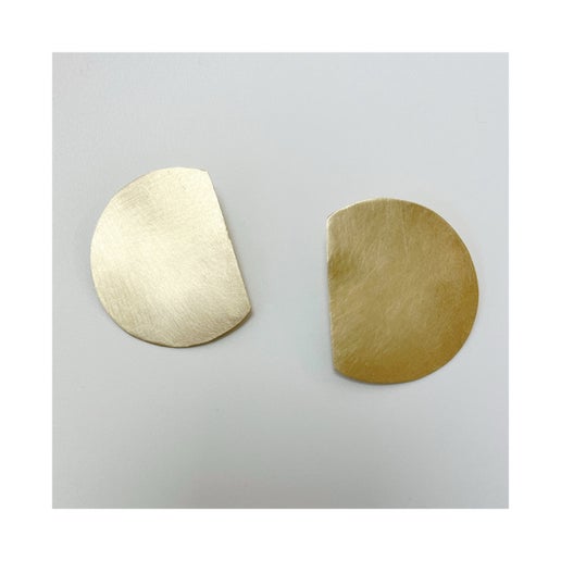 Pair of bronze earrings on a light gray background