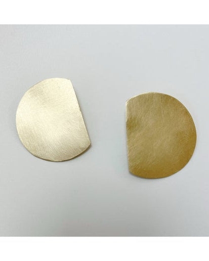 Pair of bronze earrings on a light gray background