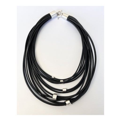 Black leather multistrand necklace with silver details on a white background