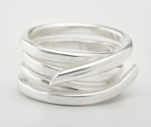 Silver ring with a textured design on a light gray background
