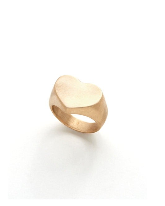 Gold heart-shaped ring on a white background