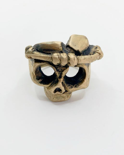 Bronze skull-shaped ring on a white background